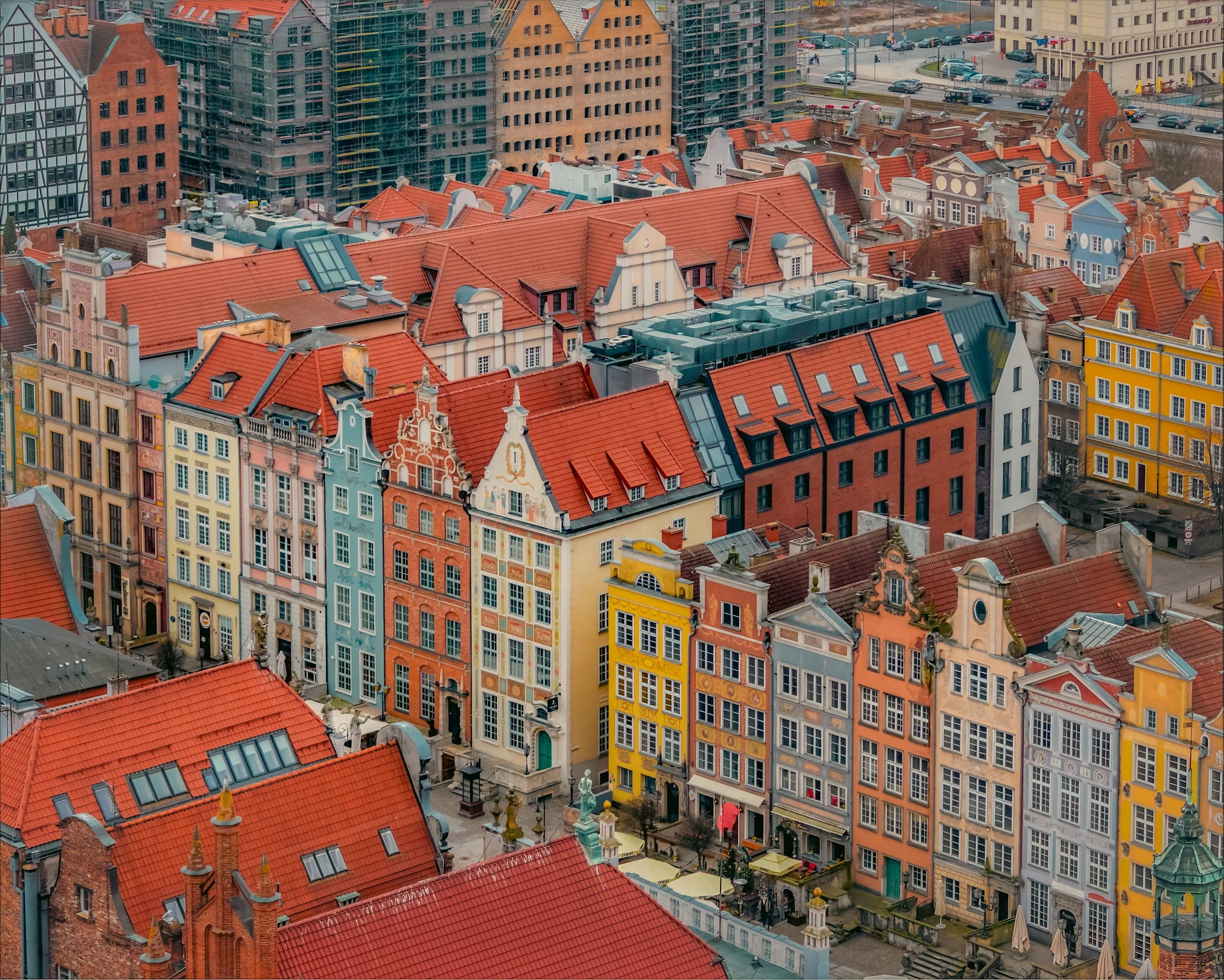 A view over dense red-tiled roofs and colourful old-town façades in Gdańsk.